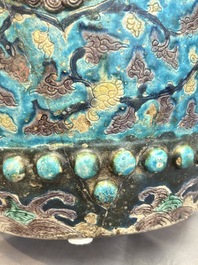 A Chinese Fahua barrel-shaped 'lotus scroll' stool with incised design, Ming