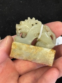 A Chinese celadon and russet jade 'dragon' seal, 18/19th C.