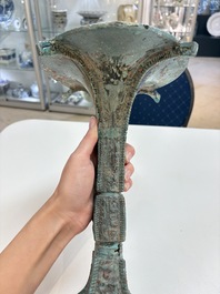 A Chinese archaic bronze wine vessel with 'taotie' design, 'gu 觚', Shang