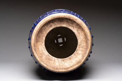 A Chinese white-slip-decorated blue-ground garden seat with floral design, 19th C.