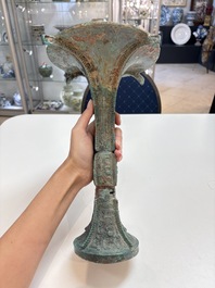 A Chinese archaic bronze wine vessel with 'taotie' design, 'gu 觚', Shang