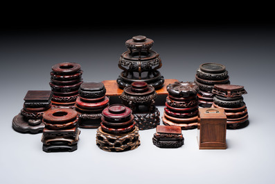 A collection of 38 Chinese wooden stands and a box, 19/20th C.