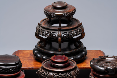 A collection of 38 Chinese wooden stands and a box, 19/20th C.