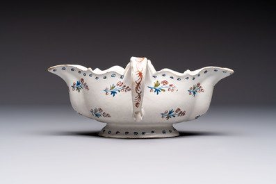 Two reticulated Brussels faience 'A la Haie Fleurie' baskets and a sauce boat, 18th C.