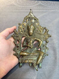 A Tibetan or Nepalese bronze seated Tara holding a vajra, 12/13th C.