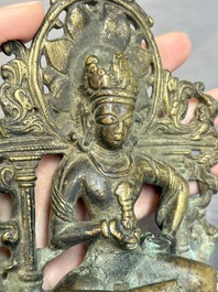 A Tibetan or Nepalese bronze seated Tara holding a vajra, 12/13th C.