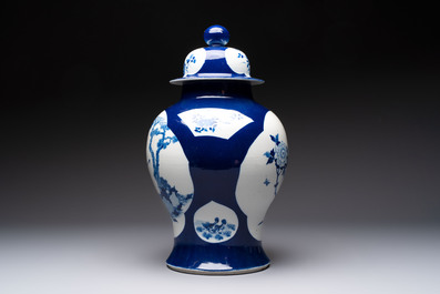 A Chinese blue and white powder-blue-ground 'He Xiangu 何仙姑' vase and cover, 19th C.