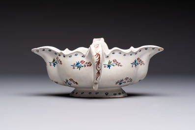 Two reticulated Brussels faience 'A la Haie Fleurie' baskets and a sauce boat, 18th C.