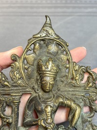 A Tibetan or Nepalese bronze seated Tara holding a vajra, 12/13th C.