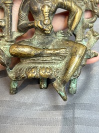 A Tibetan or Nepalese bronze seated Tara holding a vajra, 12/13th C.