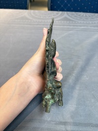 A Tibetan or Nepalese bronze seated Tara holding a vajra, 12/13th C.