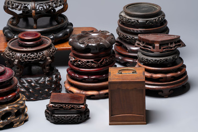 A collection of 38 Chinese wooden stands and a box, 19/20th C.