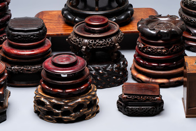 A collection of 38 Chinese wooden stands and a box, 19/20th C.
