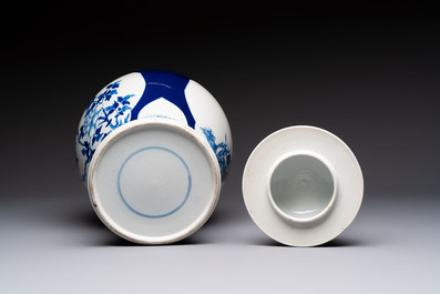 A Chinese blue and white powder-blue-ground 'He Xiangu 何仙姑' vase and cover, 19th C.