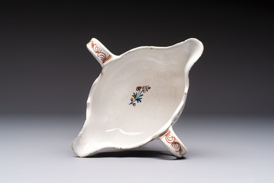 Two reticulated Brussels faience 'A la Haie Fleurie' baskets and a sauce boat, 18th C.