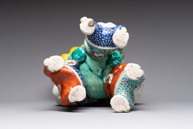 A Chinese famille rose figure of three boys holding a Buddha&rsquo;s hand, Republic