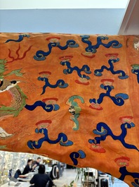 A Chinese embroidered silk salmon-ground 'dragon' robe, 19th C.