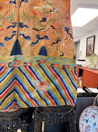 A Chinese embroidered silk salmon-ground 'dragon' robe, 19th C.