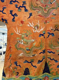 A Chinese embroidered silk salmon-ground 'dragon' robe, 19th C.
