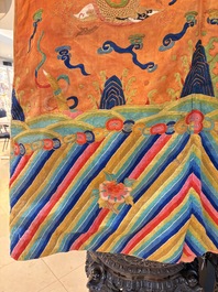 A Chinese embroidered silk salmon-ground 'dragon' robe, 19th C.