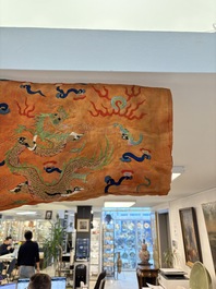 A Chinese embroidered silk salmon-ground 'dragon' robe, 19th C.