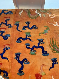 A Chinese embroidered silk salmon-ground 'dragon' robe, 19th C.