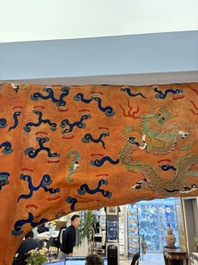 A Chinese embroidered silk salmon-ground 'dragon' robe, 19th C.
