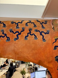 A Chinese embroidered silk salmon-ground 'dragon' robe, 19th C.