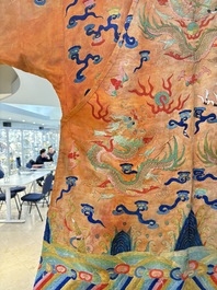 A Chinese embroidered silk salmon-ground 'dragon' robe, 19th C.