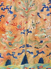 A Chinese embroidered silk salmon-ground 'dragon' robe, 19th C.
