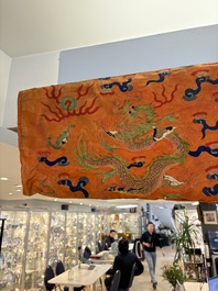 A Chinese embroidered silk salmon-ground 'dragon' robe, 19th C.