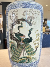 A Chinese blue, white and famille verte rouleau vase with figural and peacock design, Qianlong mark, 19th C.