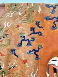A Chinese embroidered silk salmon-ground 'dragon' robe, 19th C.