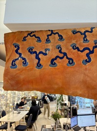 A Chinese embroidered silk salmon-ground 'dragon' robe, 19th C.