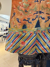 A Chinese embroidered silk salmon-ground 'dragon' robe, 19th C.