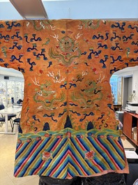 A Chinese embroidered silk salmon-ground 'dragon' robe, 19th C.