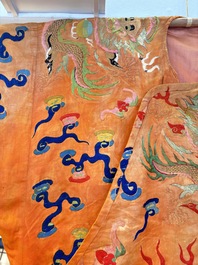 A Chinese embroidered silk salmon-ground 'dragon' robe, 19th C.