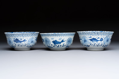 Three Chinese blue and white 'Fish' bowls and a bottle vase, Kangxi marks, 19th C.