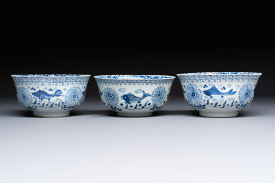 Three Chinese blue and white 'Fish' bowls and a bottle vase, Kangxi marks, 19th C.