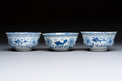 Three Chinese blue and white 'Fish' bowls and a bottle vase, Kangxi marks, 19th C.