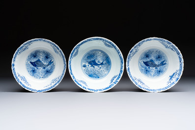 Three Chinese blue and white 'Fish' bowls and a bottle vase, Kangxi marks, 19th C.