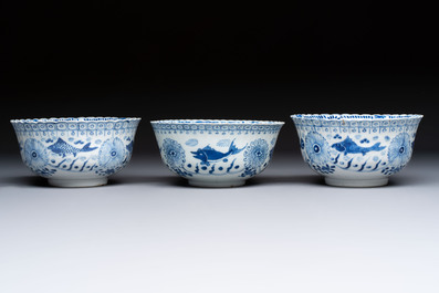 Three Chinese blue and white 'Fish' bowls and a bottle vase, Kangxi marks, 19th C.