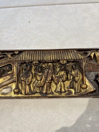 Six Chinese gilt-lacquered carved wooden panels with narrative design, 19th C.