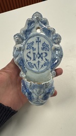 Two blue and white Dutch Delft holy water fonts, 17th C.