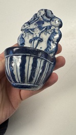 Two blue and white Dutch Delft holy water fonts, 17th C.