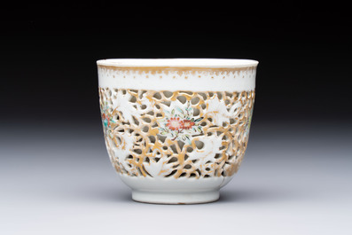 A pair of Chinese famille rose gilt-decorated covered cups and saucers and an openworked cup, Qianlong