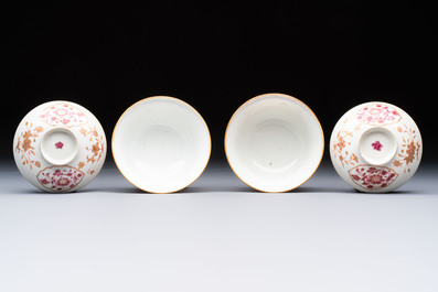 A pair of Chinese famille rose gilt-decorated covered cups and saucers and an openworked cup, Qianlong