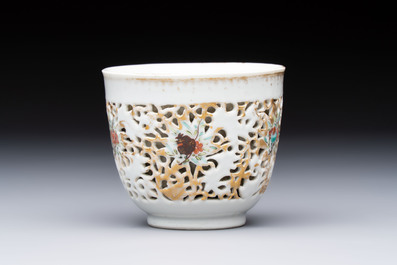 A pair of Chinese famille rose gilt-decorated covered cups and saucers and an openworked cup, Qianlong