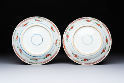 A pair of Chinese famille verte 'Ladies in a Garden' plates, Kangxi