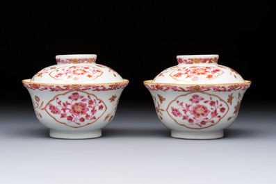 A pair of Chinese famille rose gilt-decorated covered cups and saucers and an openworked cup, Qianlong